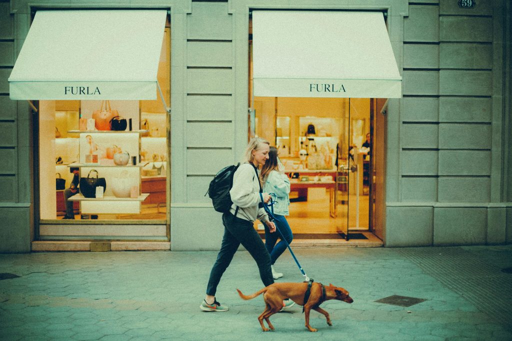 Woman Walking a Dog in City